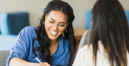 Woman smiling whilst conducting an interview