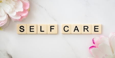 self care scrabble lettered with flowers