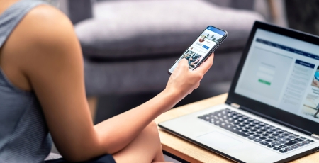 Woman crating Linkedin Profile on laptop and phone